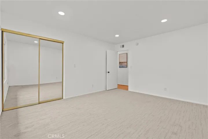 Bedroom with mirror closet doors.