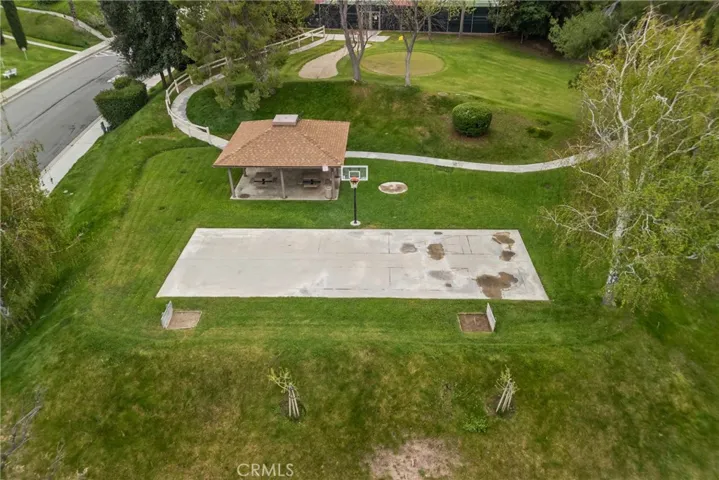 HOA sports court, grass area and covered seating.