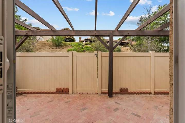 Private backyard patio with hill behind.