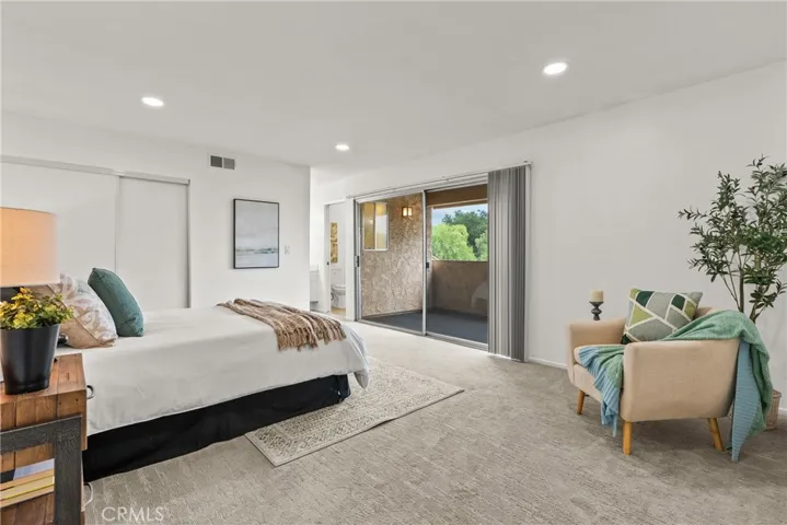 Primary bedroom with balcony