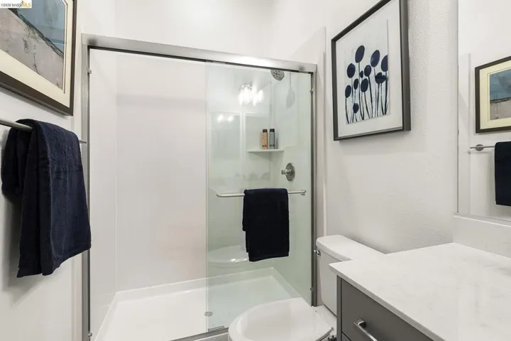 Full bath with vanity and a shower stall