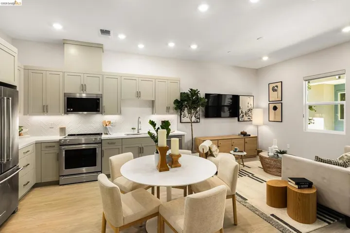 Kitchen with premium appliances, tasteful backsplash, light wood-type flooring, light countertops, and recessed lighting
