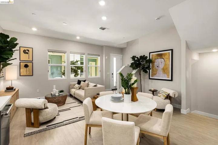 Dining room with light wood-style flooring and recessed lighting