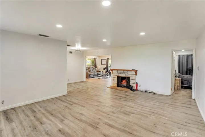 Living room with warm fireplace and canned. lighting.