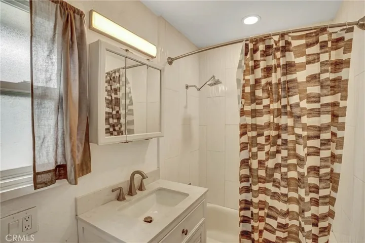 Hall bathroom with remodeled shower and vanity.
