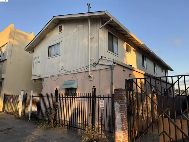 View of front of house with a fenced front yard and a gate