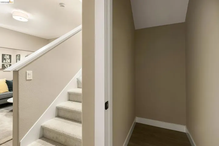 Staircase featuring wood finished floors and baseboards