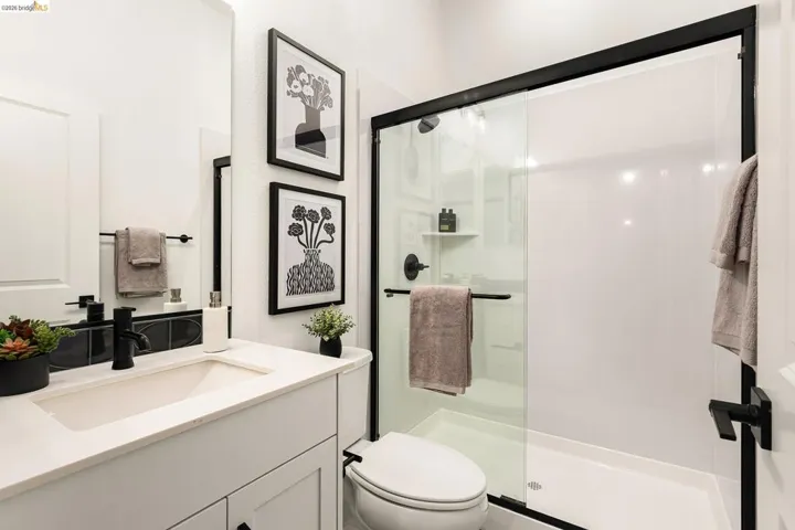 Full bathroom featuring a stall shower and vanity