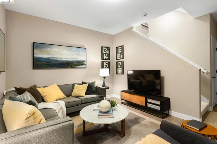 Living area with light wood-type flooring and stairs