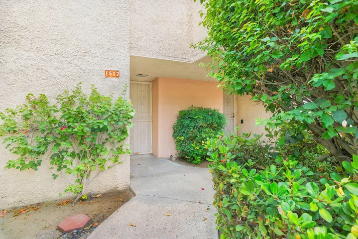 Condo entrance with fruit trees