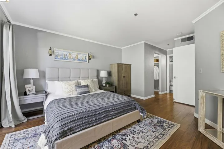 Bedroom featuring ornamental molding and dark wood-style floors