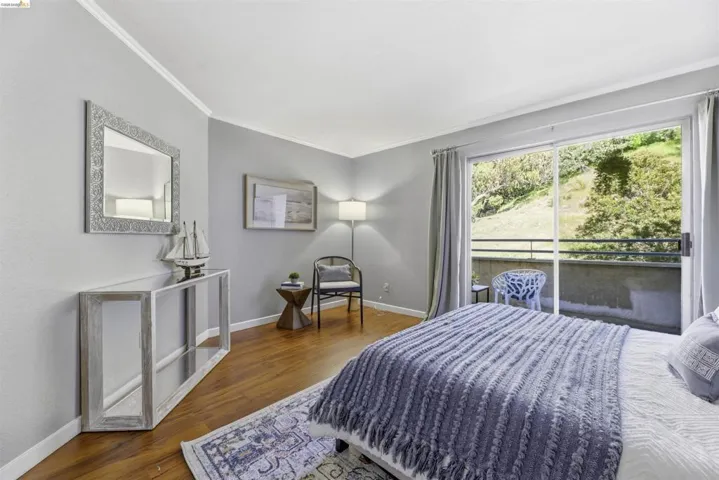 Bedroom with dark wood-style flooring and ornamental molding