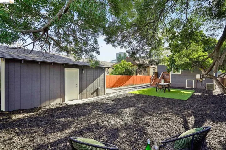 Fenced yard featuring an outbuilding