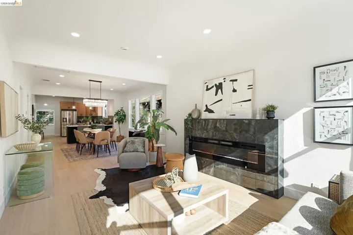 Living area featuring light wood-style flooring, a fireplace, and recessed lighting
