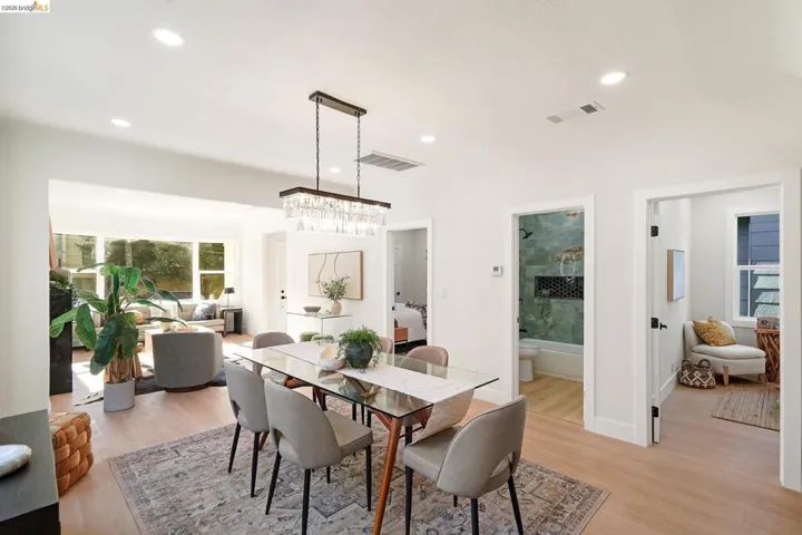 Dining space featuring light wood-style flooring, a chandelier, and recessed lighting