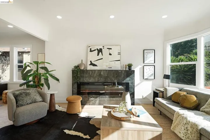 Living area featuring a premium fireplace, recessed lighting, and wood finished floors