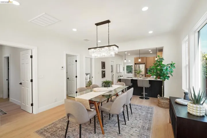 Dining area with light wood-style flooring and recessed lighting