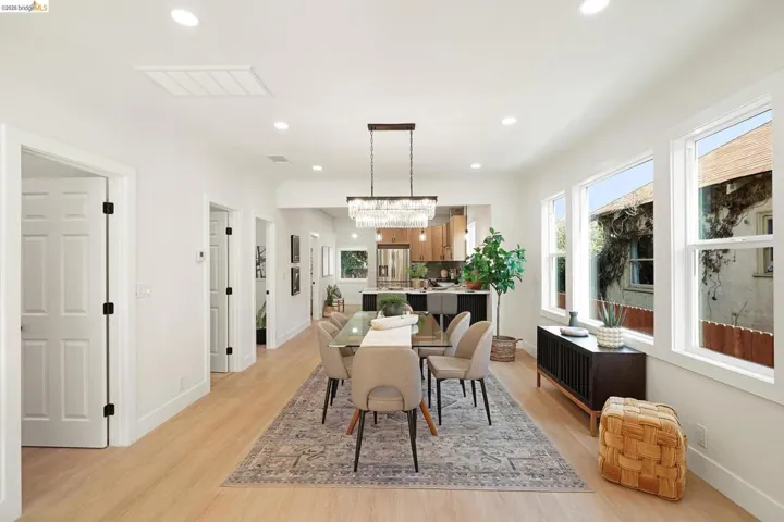 Dining room with light wood finished floors, recessed lighting, and a chandelier