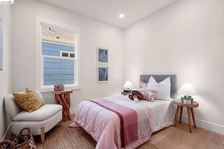 Bedroom with wood finished floors and recessed lighting