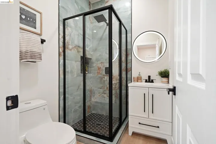 Full bath with vanity and a marble finish shower