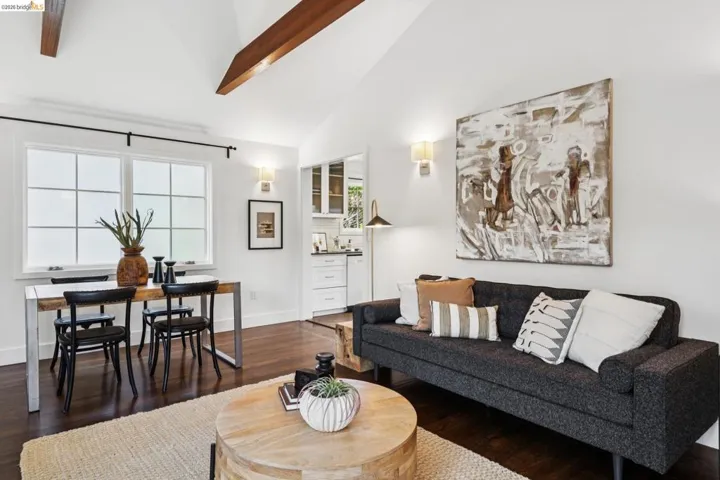 Living area with dark wood-type flooring and vaulted ceiling