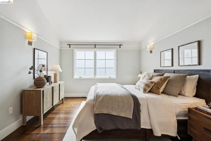 Bedroom featuring lofted ceiling and dark wood-style flooring