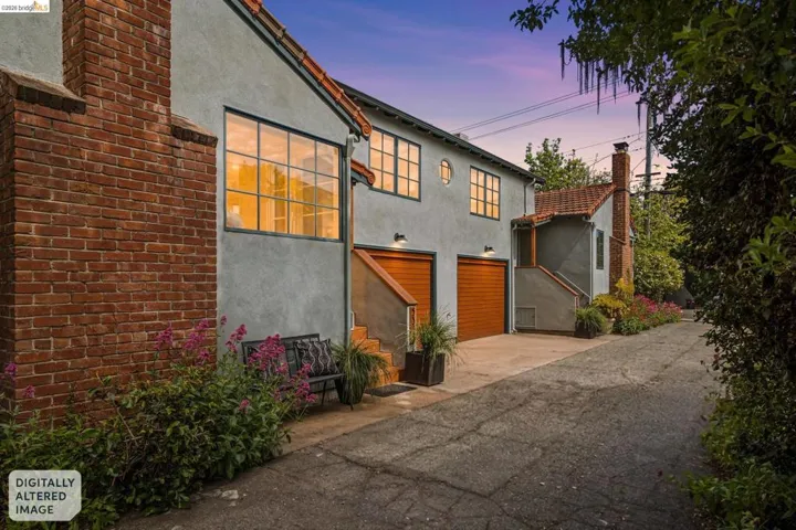 View of front of house with stucco siding, a garage, a chimney, and asphalt driveway