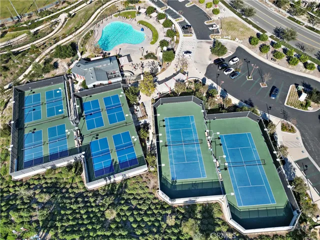 Aerial recreation amenities including tennis courts and resort-style gathering spaces.