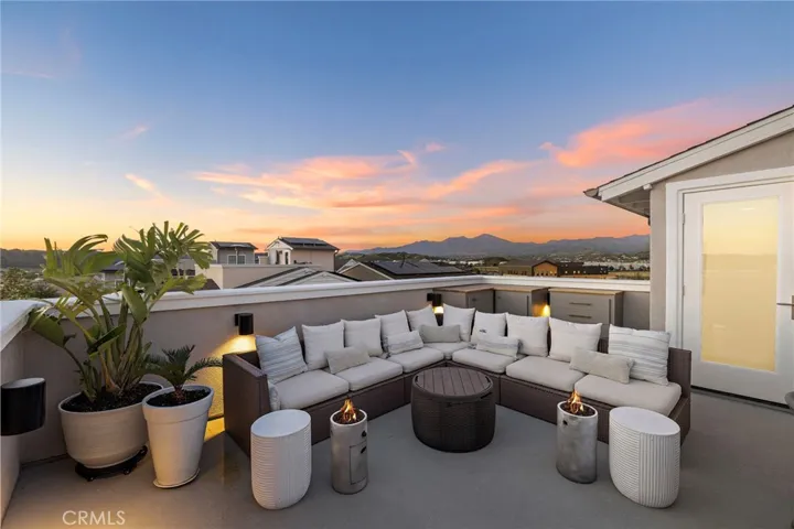Sky lounge glowing at dusk with open-air comfort and stylish seating.