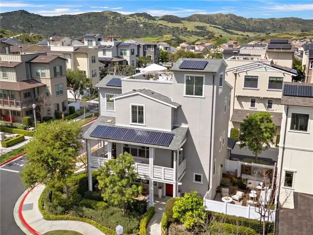 Aerial perspective highlighting the home’s scale, setting, and outdoor-living spaces.