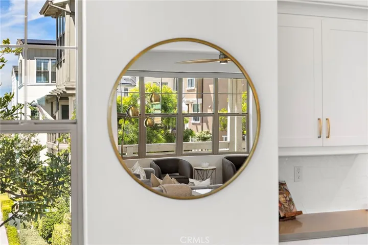 Designer mirror detail enhancing light and spatial depth.