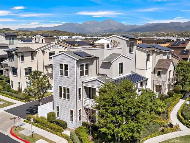 Side aerial showcasing modern design and desirable corner-lot orientation.