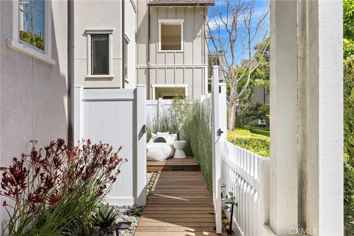 Private side path leading to a tranquil outdoor lounge.