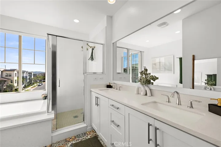 Spacious primary bath with dual vanity and airy layout.
