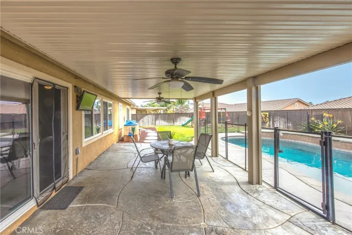 Patio with cover, ceiling fans, lighting and stamped concrete