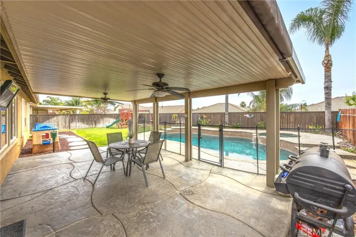 Patio with cover, ceiling fans, lighting and stamped concrete