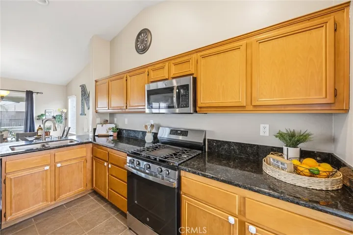 Kitchen with built-in microwave and gas stove/oven