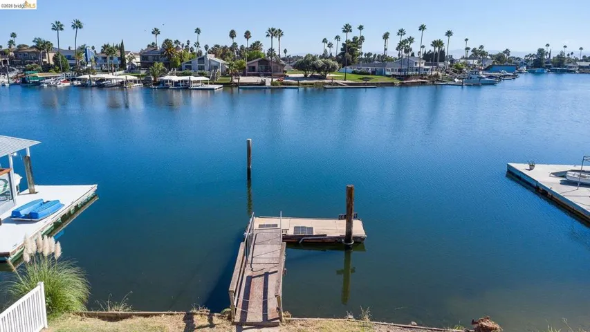 Dock area with a residential view and a water view
