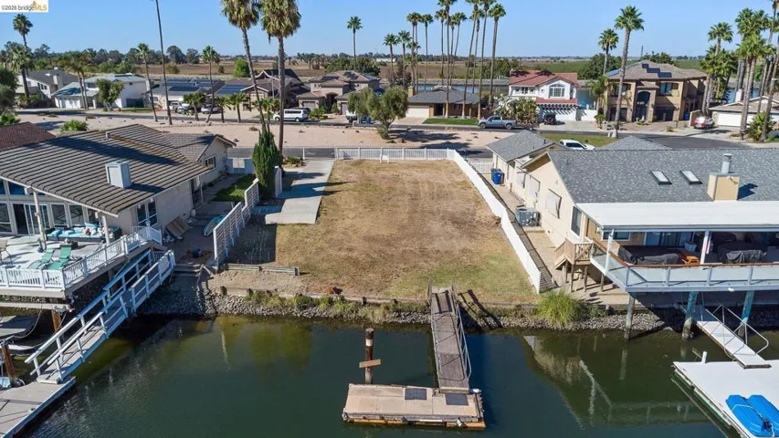 Aerial perspective of suburban area featuring a large body of water