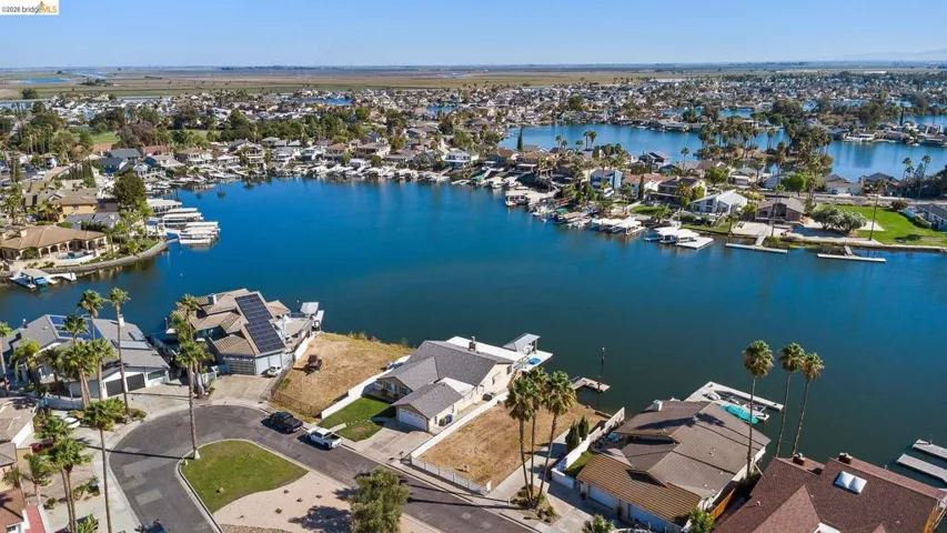 Aerial perspective of suburban area featuring a large body of water