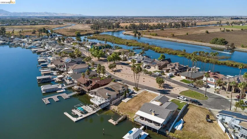 Aerial perspective of suburban area featuring a nearby body of water