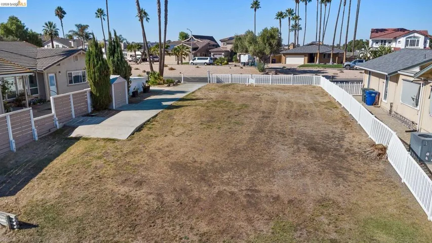 Fenced yard featuring a residential view