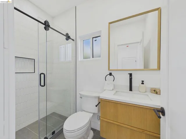 Bathroom with vanity and a shower stall