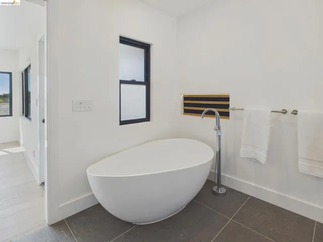 Bathroom featuring a freestanding bath and tile patterned floors