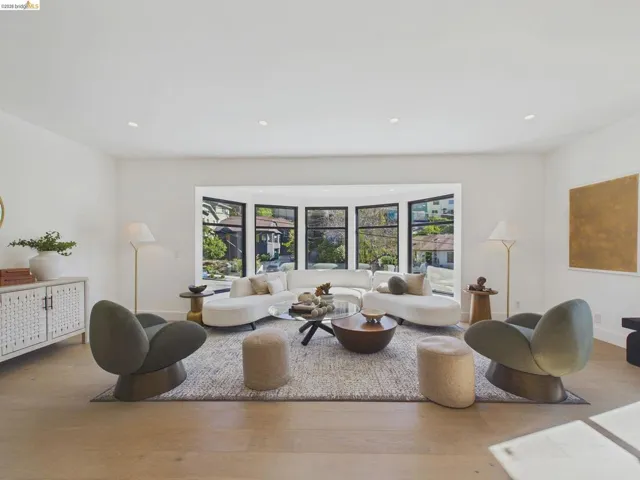 Living area with wood finished floors and recessed lighting