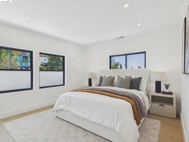 Bedroom featuring multiple windows, recessed lighting, and light wood-type flooring
