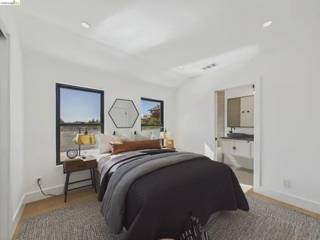 Bedroom with lofted ceiling, recessed lighting, and light wood finished floors