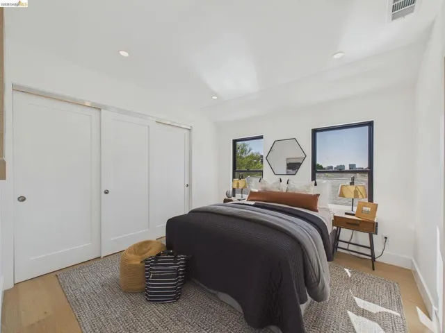 Bedroom with light wood-style flooring, a closet, recessed lighting, and vaulted ceiling