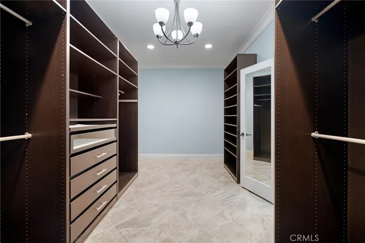 Primary bedroom walk-in closet