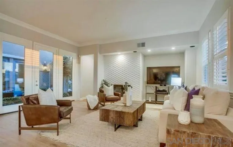 Living room with fireplace and backyard golf course and ocean views